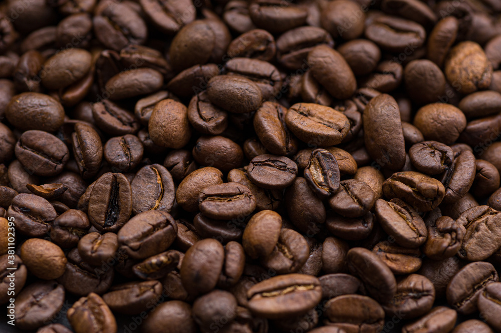 roasted aromatic coffee beans closeup sprinkled on a table roasted aromatic coffee beans closeup sprinkled on a table