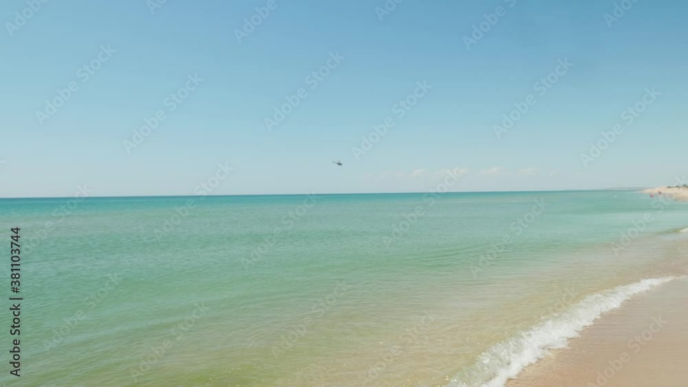 Helicopter flying above the sea near the beach. Coast guard. Helicopter flying above the sea near the beach. Coast guard.