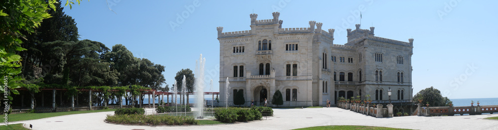 Fototapeta premium Miramare – panorama of the Park in front of the white Castle facade with the sea in the background