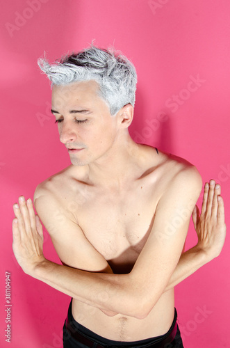 Young attractive guy. Pink background.