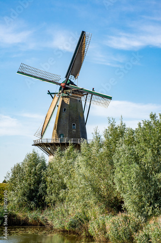 Flour windmill 'Nooit gedagt' on the waterfront of the fortified town of Woudrichem in summer in the Netherlands