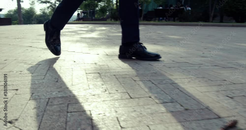 the legs of a businessman filmed almost walking, shoes and pants. the legs of a businessman filmed almost walking, shoes and pants.
