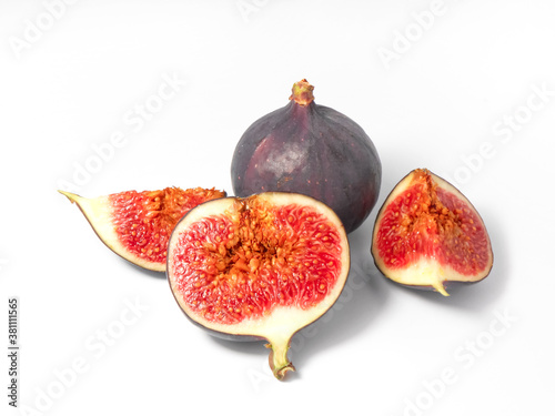 Fresh ripe whole and sliced figs on a white background.