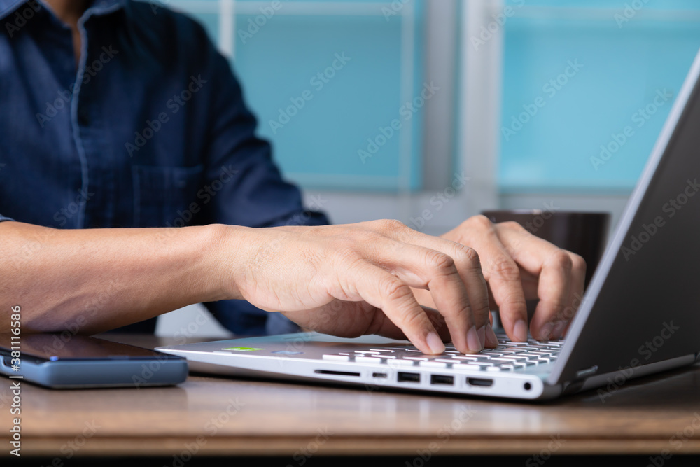 Man's hands typing on laptop keyboard. Man's hands typing on laptop keyboard.