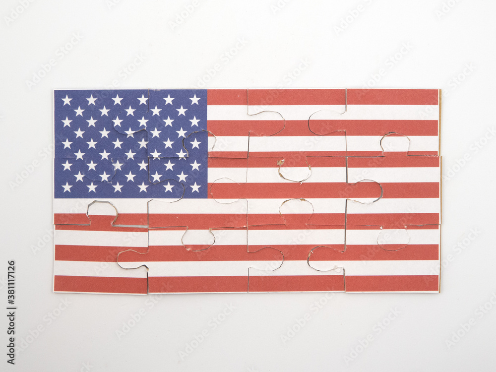 Jigsaw puzzle with picture of American flag put together in front of white background - obrazy, fototapety, plakaty 