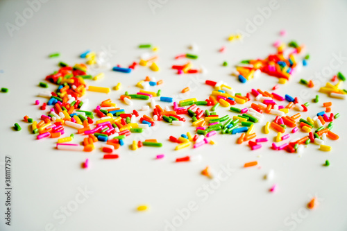 Selective focus colorful sugar sprinkle dots for decoration topping cake and ice cream on the table.