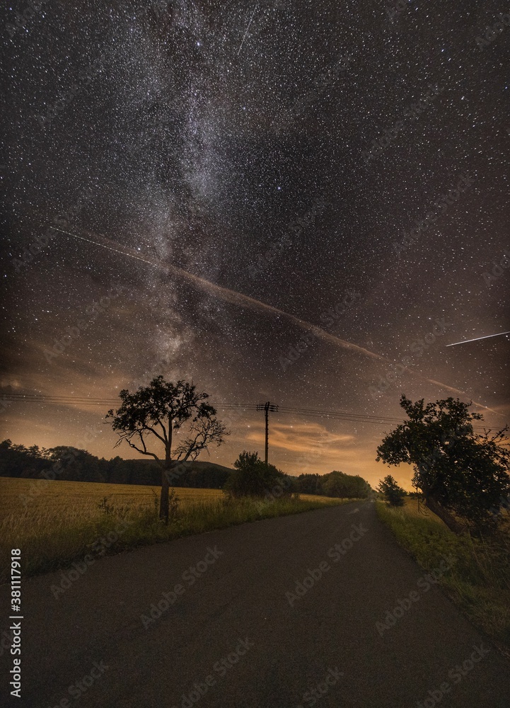 Countryside road under sky full of stars