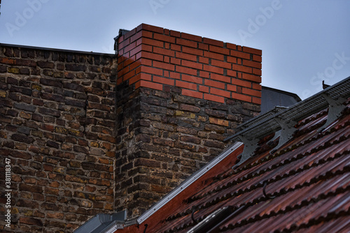 Chimney on an old house made of old and new bricks