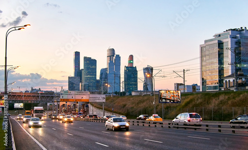 Evening traffic and sunset over skyscrapers of Moscow city business centre in early autumn