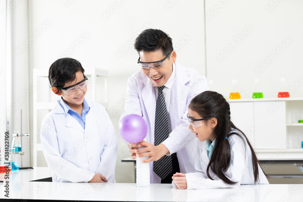 science teacher doing or testing balloon blow up experiment from bottle with child students science teacher doing or testing balloon blow up experiment from bottle with child students