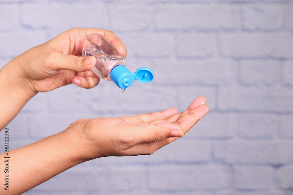 women hand using sanitizer gel for preventing virus with copy space 