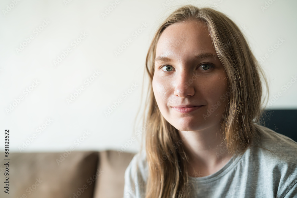 young woman relaxing on a couch with sunlight from a window young woman relaxing on a couch with sunlight from a window