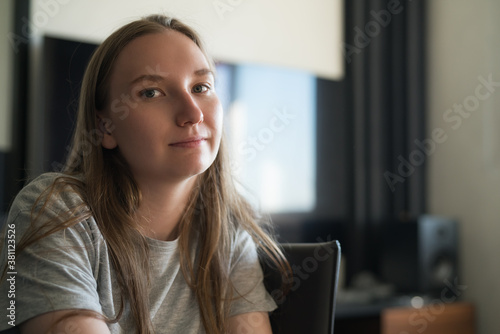 girl sitting on a chair with sunlight from a window