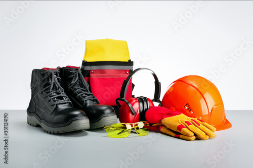 Industrial protective wear-protective shoes, safety glasses, gloves and hearing protection. photo