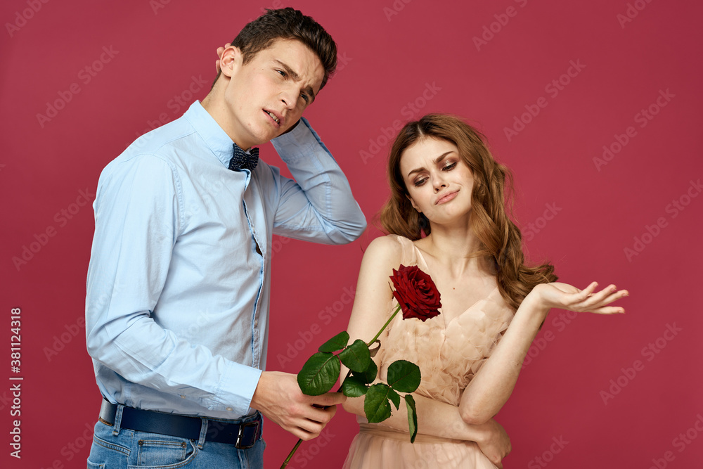 Lovers people with rose in hands on pink isolated background hug emotions happiness romance feelings Lovers people with rose in hands on pink isolated background hug emotions happiness romance feelings
