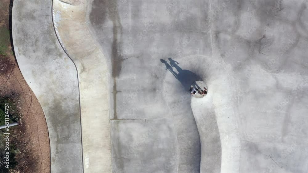 Skater riding a Scooter in a large skate park, Aerial view.
