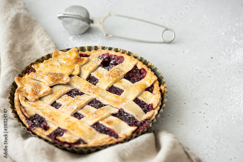 homemade raspberry pie made from crumbly dough on a white table