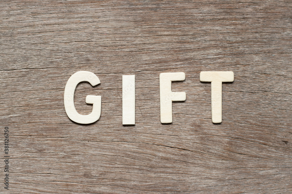 Alphabet letter in word gift on wood background Alphabet letter in word gift on wood background