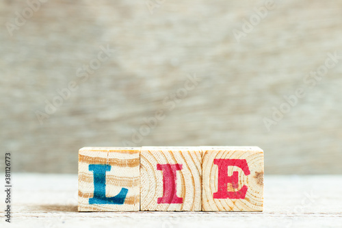 Alphabet letter in word lie on wood background photo