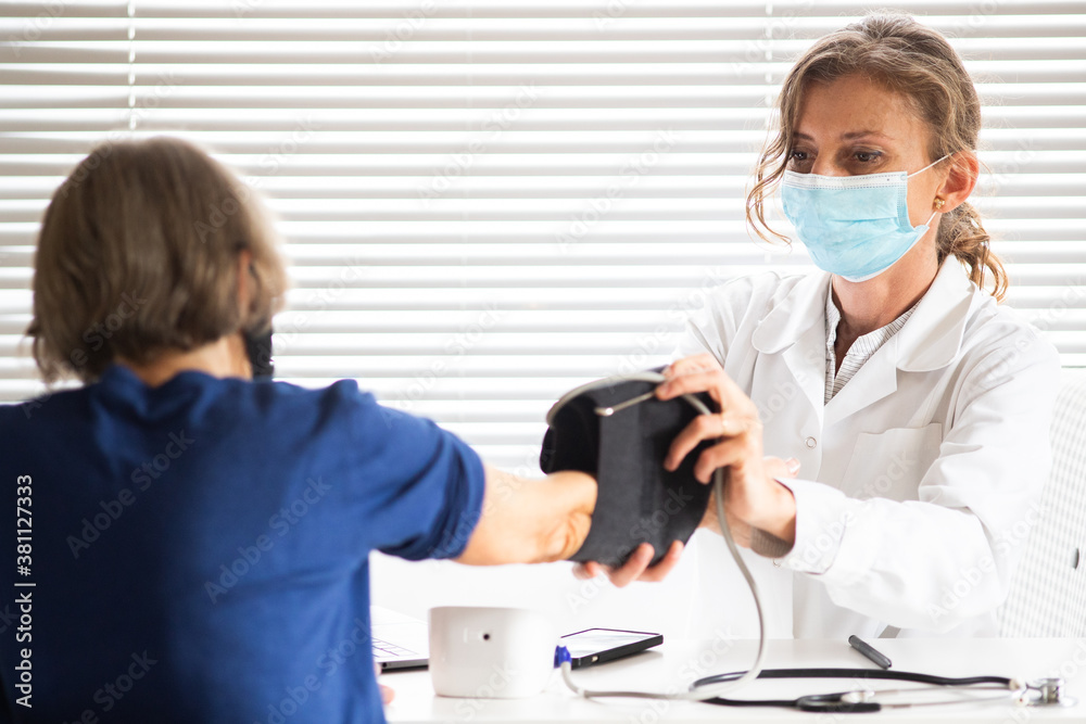 female doctor consulting a patient wearing medical mask
