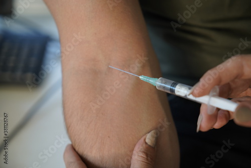Vaccination concept. Female doctor vaccinating young man Doctor vaccinating male patient in clinic  closeup