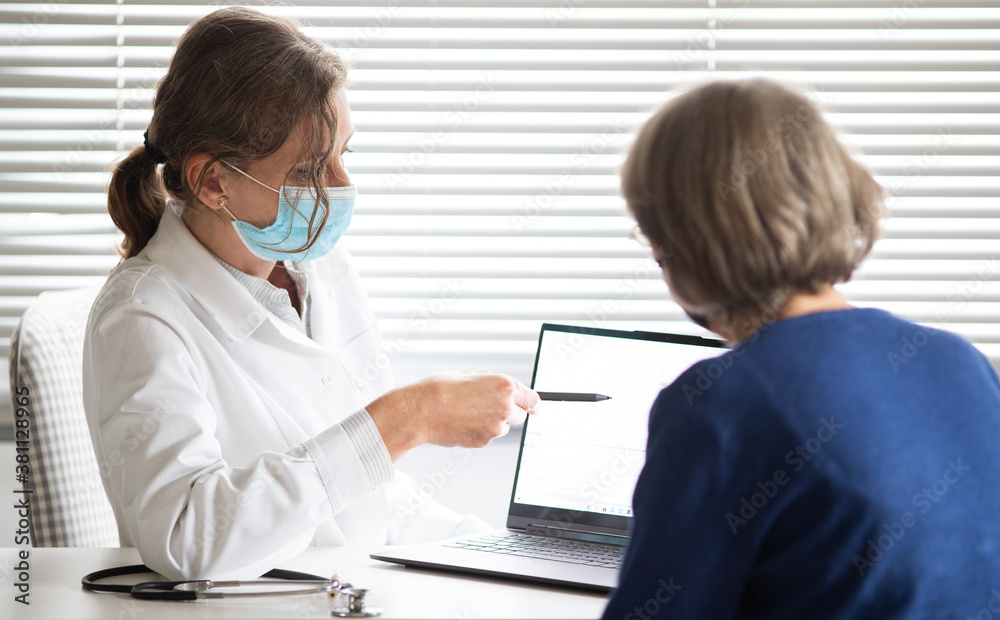 female doctor consulting a patient wearing medical mask female doctor consulting a patient wearing medical mask