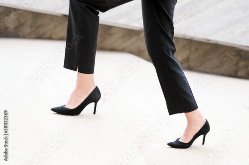 Businesswoman wearing heels climbing the Stairs in the city. Slow motion Close up on legs. High quality image.