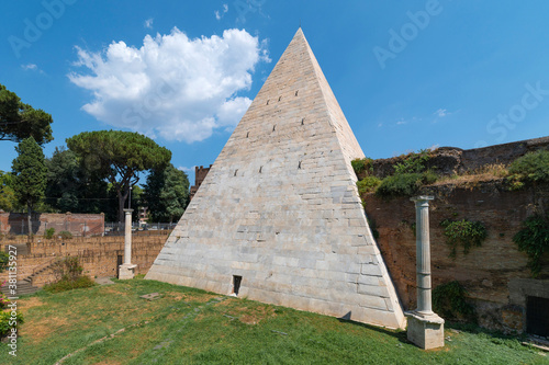 The Piramide Cestia or Pyramid of Cestius seen from the park of the non-Catholic cemetery is the only Egyptian-style pyramid in Rome. In the background the Aurelian walls at Porta San Paolo. Italy.