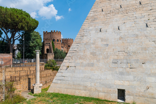 The Piramide Cestia or Pyramid of Cestius seen from the park of the non-Catholic cemetery is the only Egyptian-style pyramid in Rome. In the background the Aurelian walls at Porta San Paolo. Italy. photo