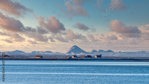 View from Reykjavik across the bay to Bessastadir, the official residence of the President of Iceland. The cone of the volcano Keilir is visible in the background.
