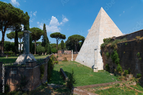 The Piramide Cestia or Pyramid of Cestius seen from the park of the non-Catholic cemetery is the only Egyptian-style pyramid in Rome. In the background the Aurelian walls at Porta San Paolo. Italy. photo