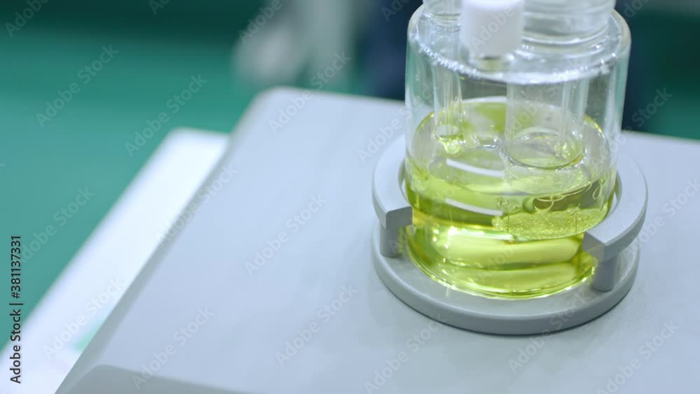 Magnetic mixer stirrer with fast moving stir bar for mixing liquid at pharmacy lab, medical exhibition: close up, super slow motion. Chemistry, science, pharmaceutical, laboratory equipment concept. Magnetic mixer stirrer with fast moving stir bar for mixing liquid at pharmacy lab, medical exhibition: close up, super slow motion. Chemistry, science, pharmaceutical, laboratory equipment concept.