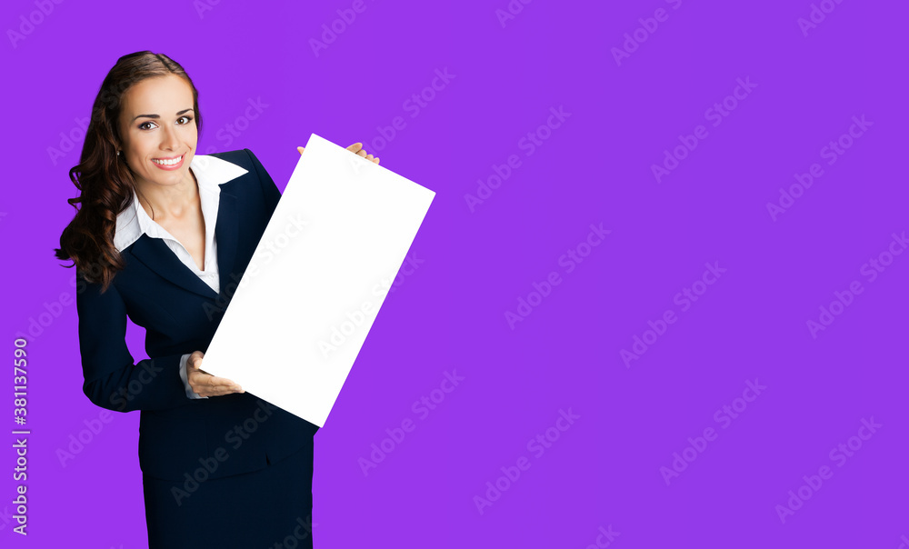 Happy smiling woman in black confident suit and white blouse showing blank signboard. Business and advertising concept. Copy space empty place for some text. Violet purple color background.. Happy smiling woman in black confident suit and white blouse showing blank signboard. Business and advertising concept. Copy space empty place for some text. Violet purple color background..