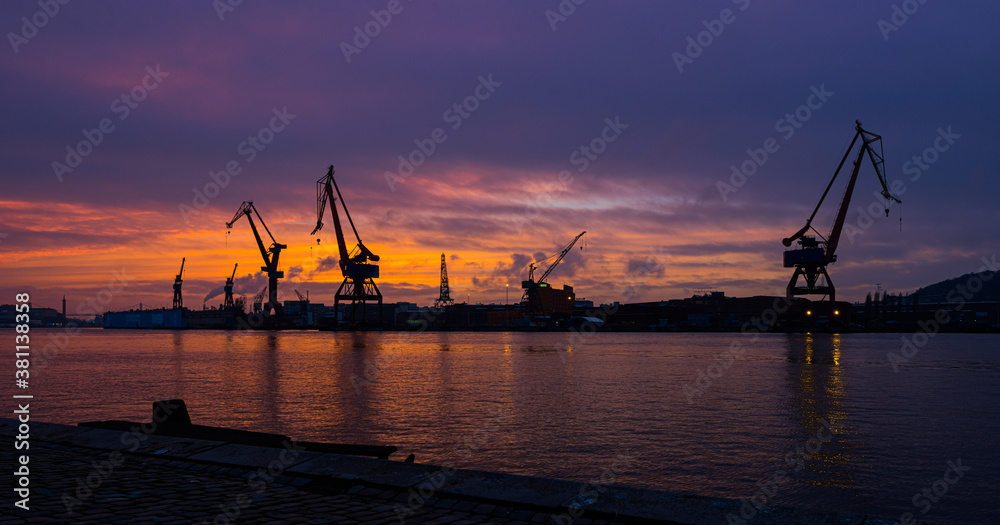 Silhouettes of cranes at an old wharf. Silhouettes of cranes at an old wharf.