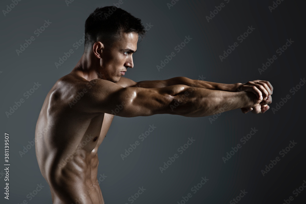 Portrait of handsome young man with stylish haircut posing over gray background. Perfect body & skin. Close up. Studio shot