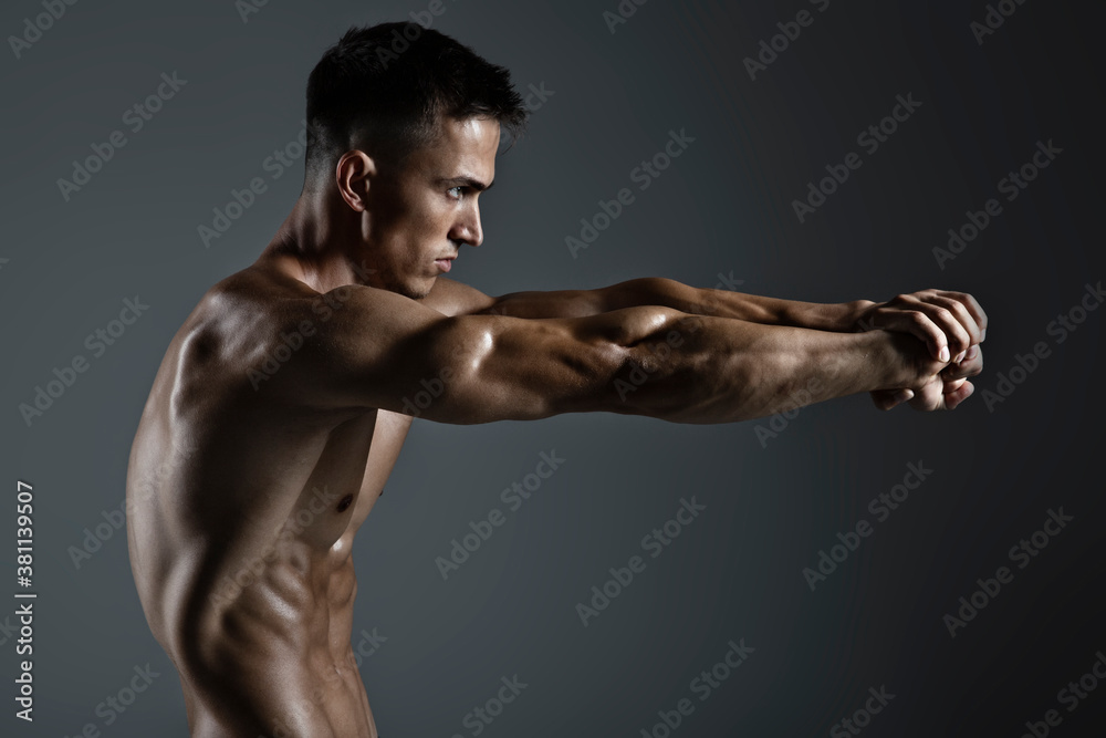 Portrait of handsome young man with stylish haircut posing over gray background. Perfect body & skin. Close up. Studio shot Portrait of handsome young man with stylish haircut posing over gray background. Perfect body & skin. Close up. Studio shot