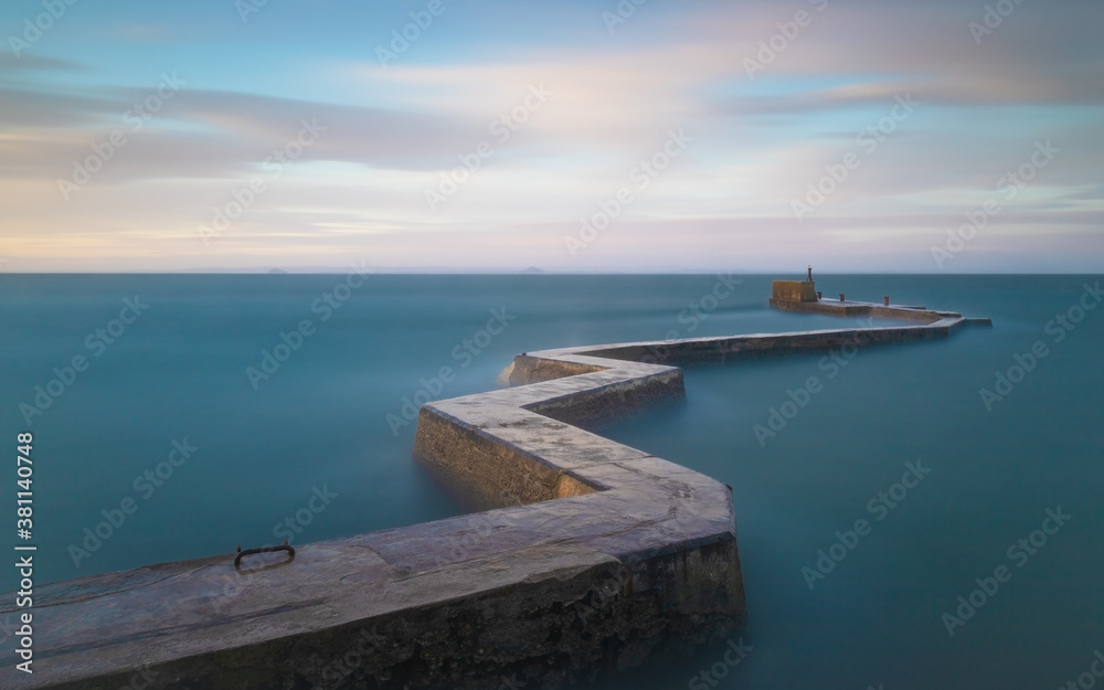 A long exposure shot of the zigzag breakwater at St Monans during some stormy weather - the long exposure smooths out the water giving the appearance of calm
