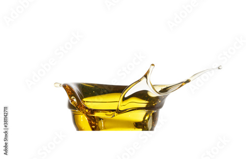 Automotive engine oil (lubricating oil, yellow liquid oil) splash and isolated on white background. Maintenance, service, and energy fuel concept. . photo