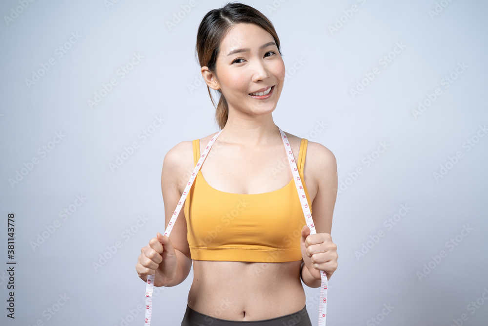 Happy young Asian woman in sportswear smiling and looking at the camera, Isolated on white background. Happy young Asian woman in sportswear smiling and looking at the camera, Isolated on white background.