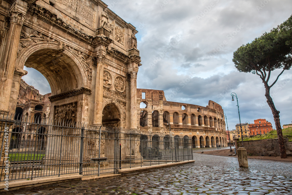Scenic view of Ancient Roman ruins in the Rome center. The Colosseum and Arch of Constantine in Rome - famous Roman buildings, Rome, Italy