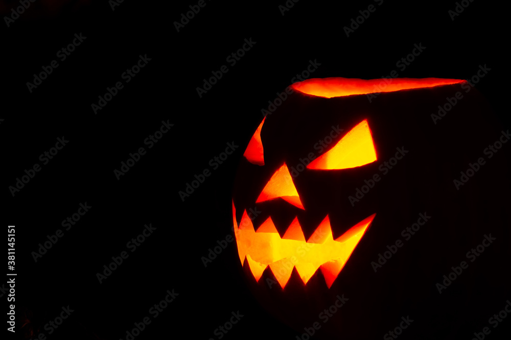 halloween pumpkin on a tree stump on a dark night halloween pumpkin on a tree stump on a dark night