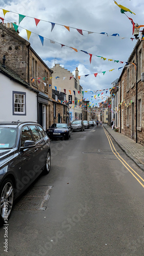 Edinburgh, Scotland; August 5, 2019. Small street in Crail with cars and decorated for Scottish festivities
