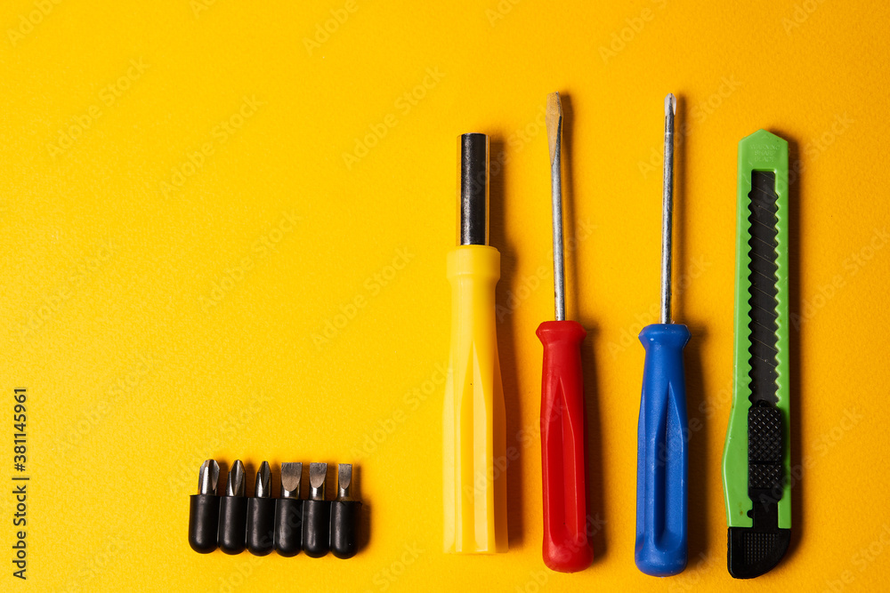 screwdrivers and construction tools on yellow background equipment for repair industry screwdrivers and construction tools on yellow background equipment for repair industry