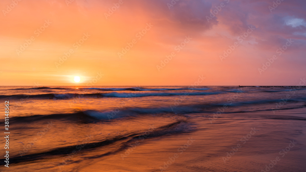 Sunrise above ocean waves