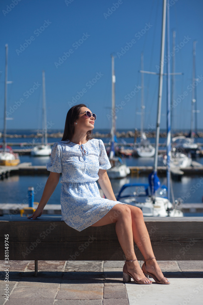 woman in dress near the yachts