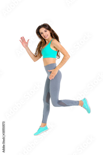 Woman in sportswear doing exercises on the body warm up jogging

