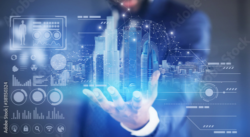 Creative collage of businessman holding virtual smart city hologram and digital interface