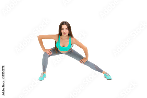 Woman in sportswear doing warm-up before jogging 
