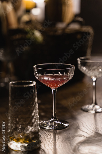 Glasses with alcoholic drink on bar counter. 