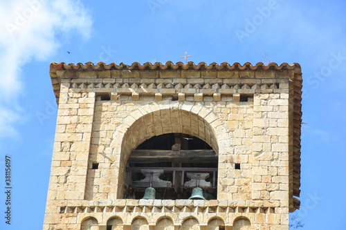 Obraz na płótnie BEGET, CATALONIA, SPAIN, EUROPE, SEPTEMBER 2020. Beautiful tower of the Romanesque church of San Cristóbal surrounded by birds in the beautiful medieval town of Beget. w salonie